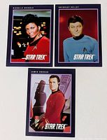 Three Star Trek portrait trading cards laid out: Nichols, Kelley, Doohan