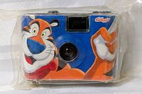 Front view showing Tony the Tiger graphic and lens
