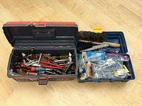 Overall view of open toolbox showing hand tools and hardware