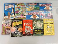 All ten softcover books laid out