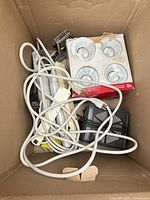 Box showing all items including LED lights package, power bars, light fixture, charger, knife, hinge, cords
