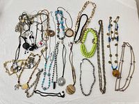 All necklaces laid out on white cloth