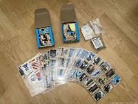 Full lot view with two opened boxes, fan of loose cards, sealed packs and inserts