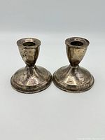 pair of sterling weighted candlesticks front view