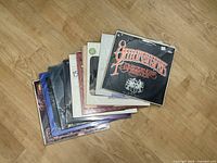 Stack of ten vinyl LPs showing spine edges and top record