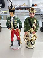 Front view of both ceramic decanters: Irish Mist soldier and Scotsman