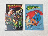 Front covers of both Superman comics side by side