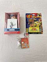 Three packaged items: Dixie Bugs Bunny dispenser, Jelly Belly Racing jelly beans, 101 Dalmatians figurine