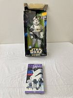 Front of boxed AT-AT Driver figure and VHS tape