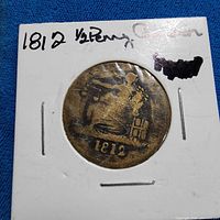 reverse in flip showing seated Britannia and 1812 date