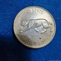 Reverse of coin showing bobcat design and inscriptions 25 CENTS CANADA 1867 1967