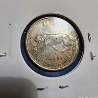 Reverse of 25-cent coin showing bobcat design in holder