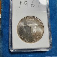Encapsulated 1967 Canada goose dollar in holder
