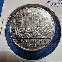 Reverse of 1982 Canadian commemorative dollar showing 1867 Confederation design