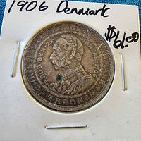 Coin in cardboard flip with year and country noted