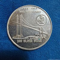 Obverse of token showing bridge design and anniversary text