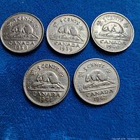 Front of all five coins showing dates 1938-1942