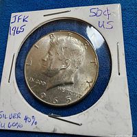 Obverse of 1965 Kennedy half dollar showing portrait and date