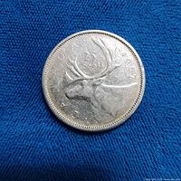 Obverse side showing caribou, date 1957 and denomination 25 cents