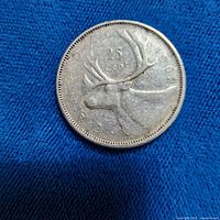 Reverse of 1962 Canadian quarter showing caribou and "25 CENTS" legend