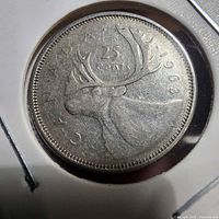 Reverse of 1963 Canadian 25¢ coin showing caribou and date