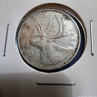 Full view of 1965 Canadian 25 cent coin in holder, caribou reverse visible