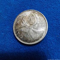 Reverse of 1965 Canadian 25-cent coin showing caribou and date