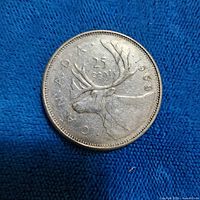 Reverse of 1968 Canadian quarter showing caribou