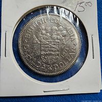 Reverse side of 1971 British Columbia dollar in holder showing provincial arms