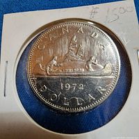 Front of 1972 Canadian Voyageur dollar in holder