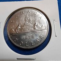 Close-up of 1972 Canadian dollar coin in holder