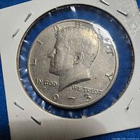 Obverse of 1973 Kennedy half dollar in flip