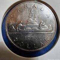 Obverse Voyageur design of 1978 Canadian dollar in holder