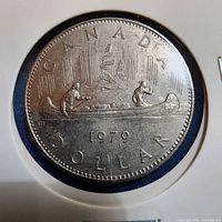 Reverse side of 1979 Canadian Voyageur dollar coin in holder