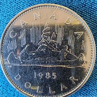 Reverse showing Voyageur canoe design and 1985 date