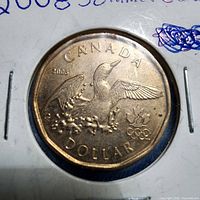 Reverse side showing loon, date and Olympic rings