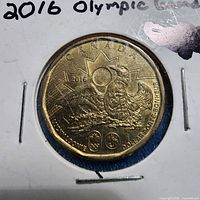 Reverse of 2016 Lucky Loonie showing loon, sun and Olympic logos