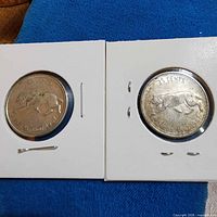 Two 1867-1967 Canadian quarters in holders