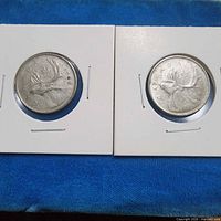 Front view of both 1968 Canadian quarters in holders