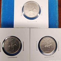 Three 1873-1973 RCMP Centennial 25-cent coins in flips