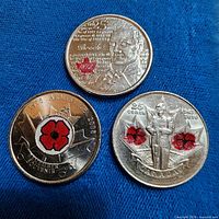 All three colourized Canadian quarters on blue background