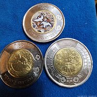 Three 2023 Canadian toonies laid out together