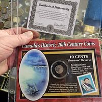 Display card with certificate of authenticity and portion of coin and stamp set