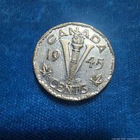 Reverse side of 1945 Canada Victory nickel showing torch and V design