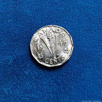 Reverse showing Victory torch design with date 1945