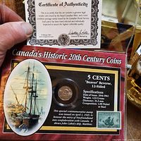 Presentation card showing coin, stamp and certificate