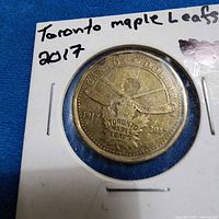 Obverse of 2017 Toronto Maple Leafs loonie in holder