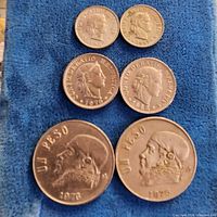All six coins laid out showing obverse design and relative sizes