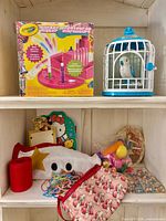 Overall lot showing Crayola Marker Maker kit, Little Live Pets bird in cage and assorted items on lower shelf