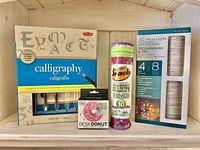 Front view of calligraphy set, Smencils tube, Desk Donut box, LED micro lights box